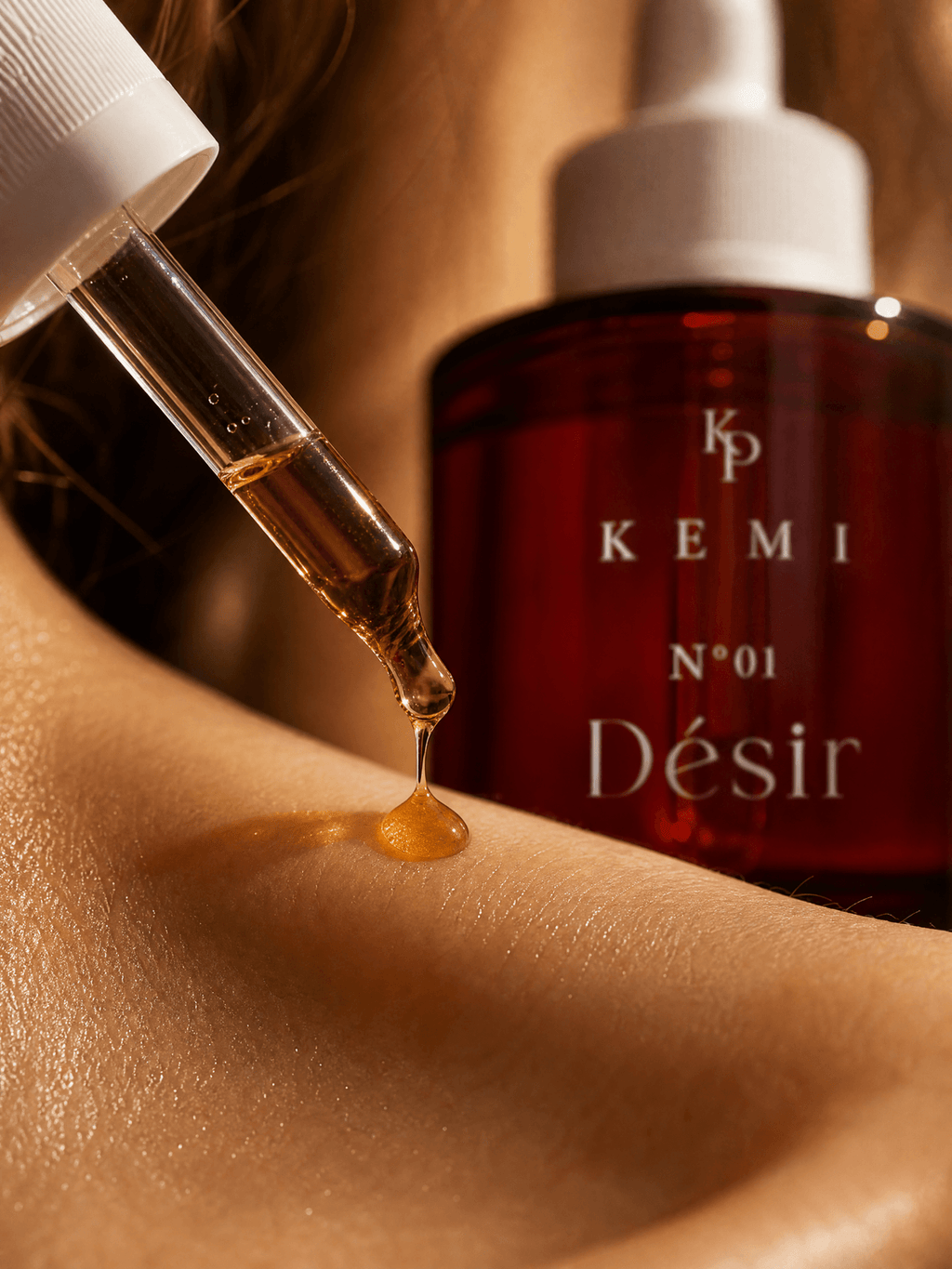 Two drops of Désir on warm skin, macro