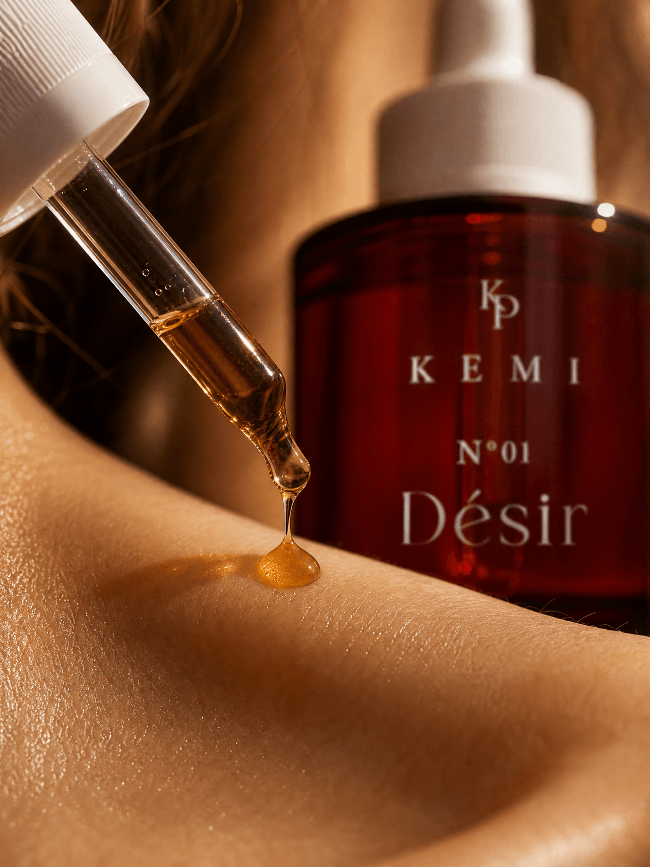 Two drops of Désir on warm skin, macro