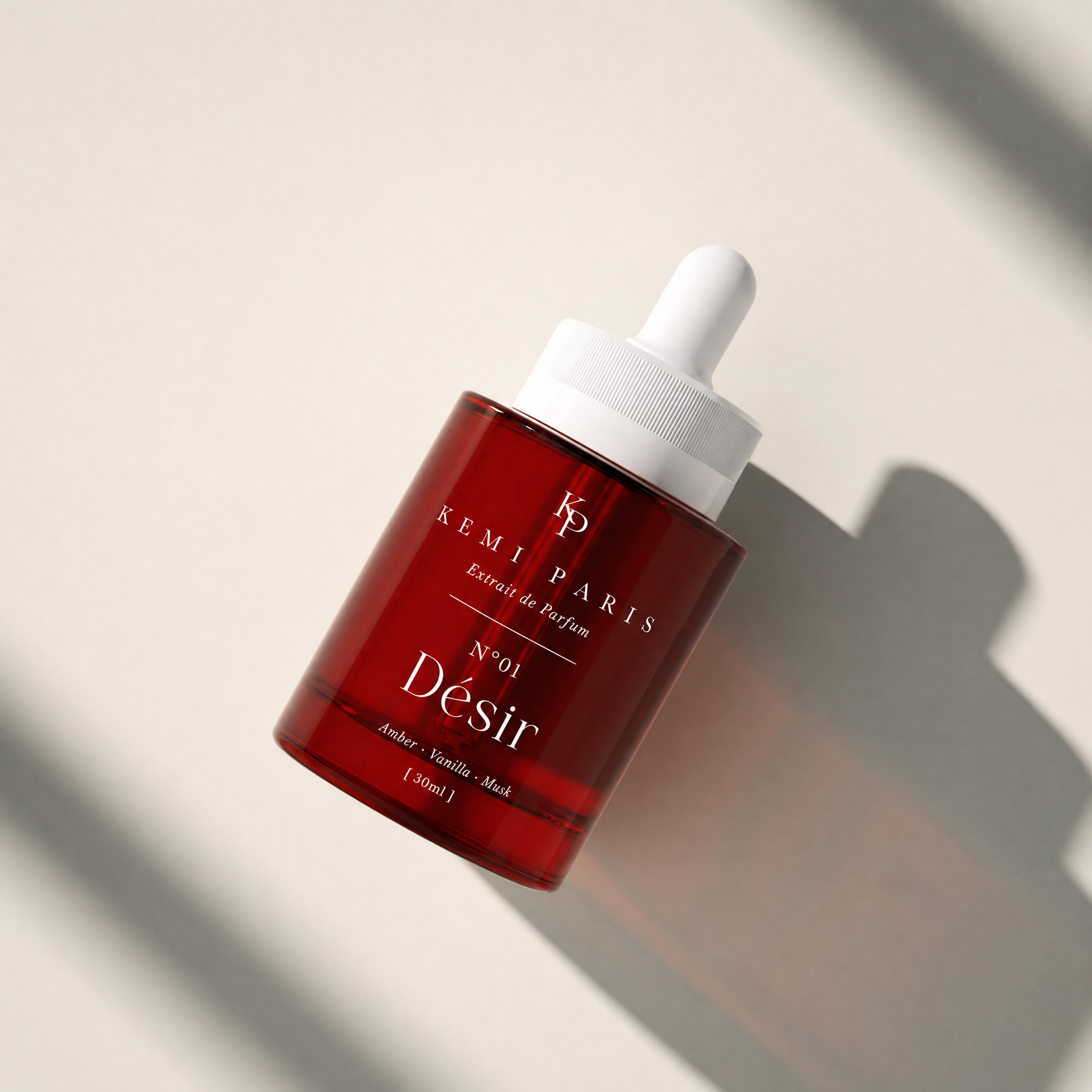 KEMI PARIS N°01 Désir bottle — tilted, window light
