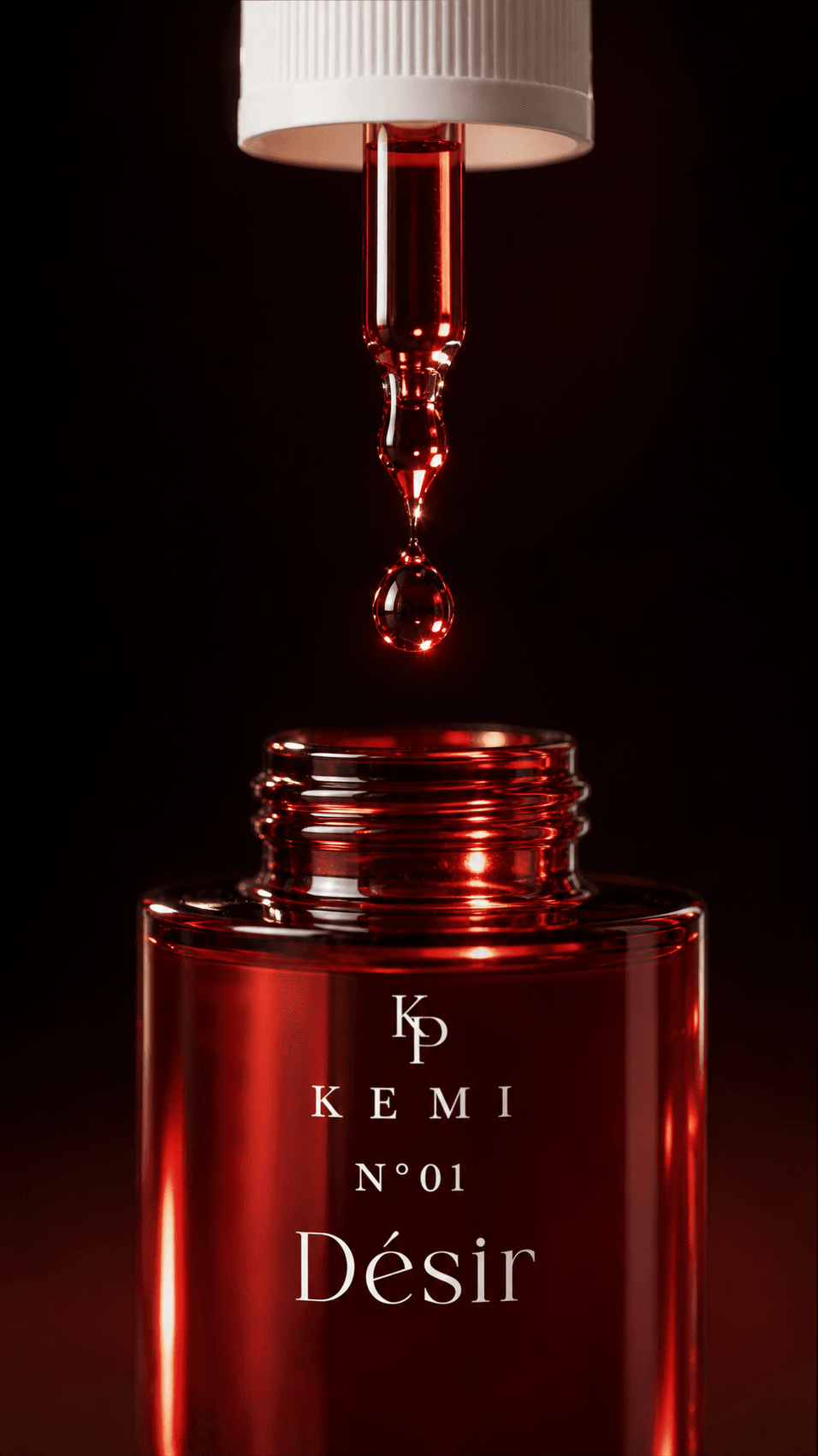 Désir extrait poured — dropper macro over the ruby bottle