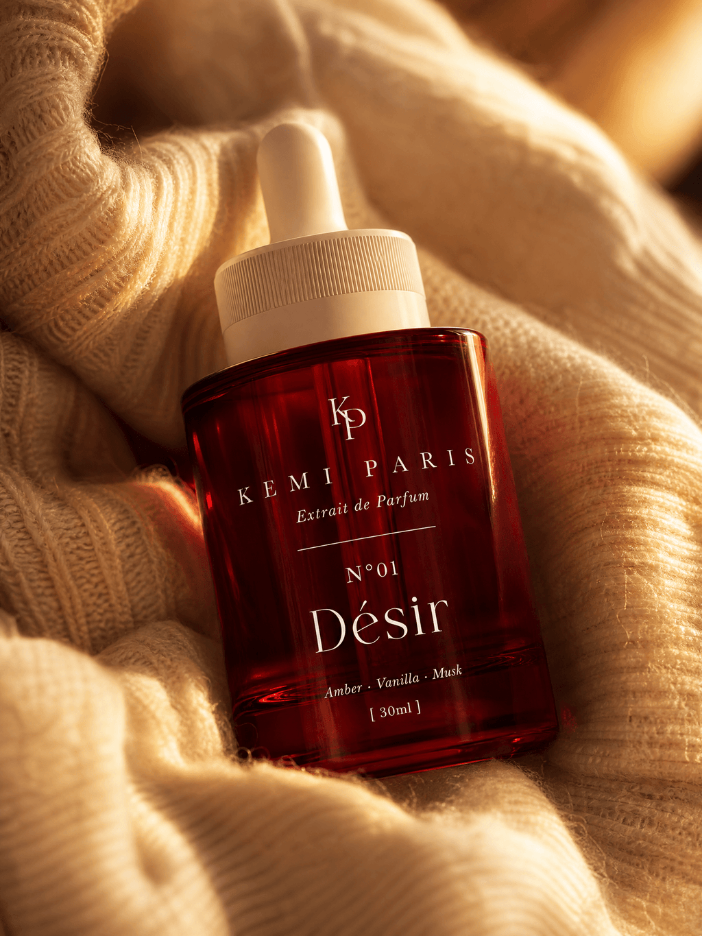 Désir extrait bottle — warm-skin still life