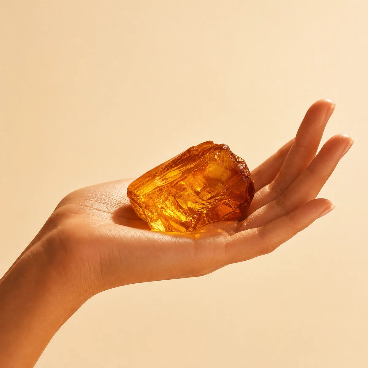 Warm amber resin held in the hand