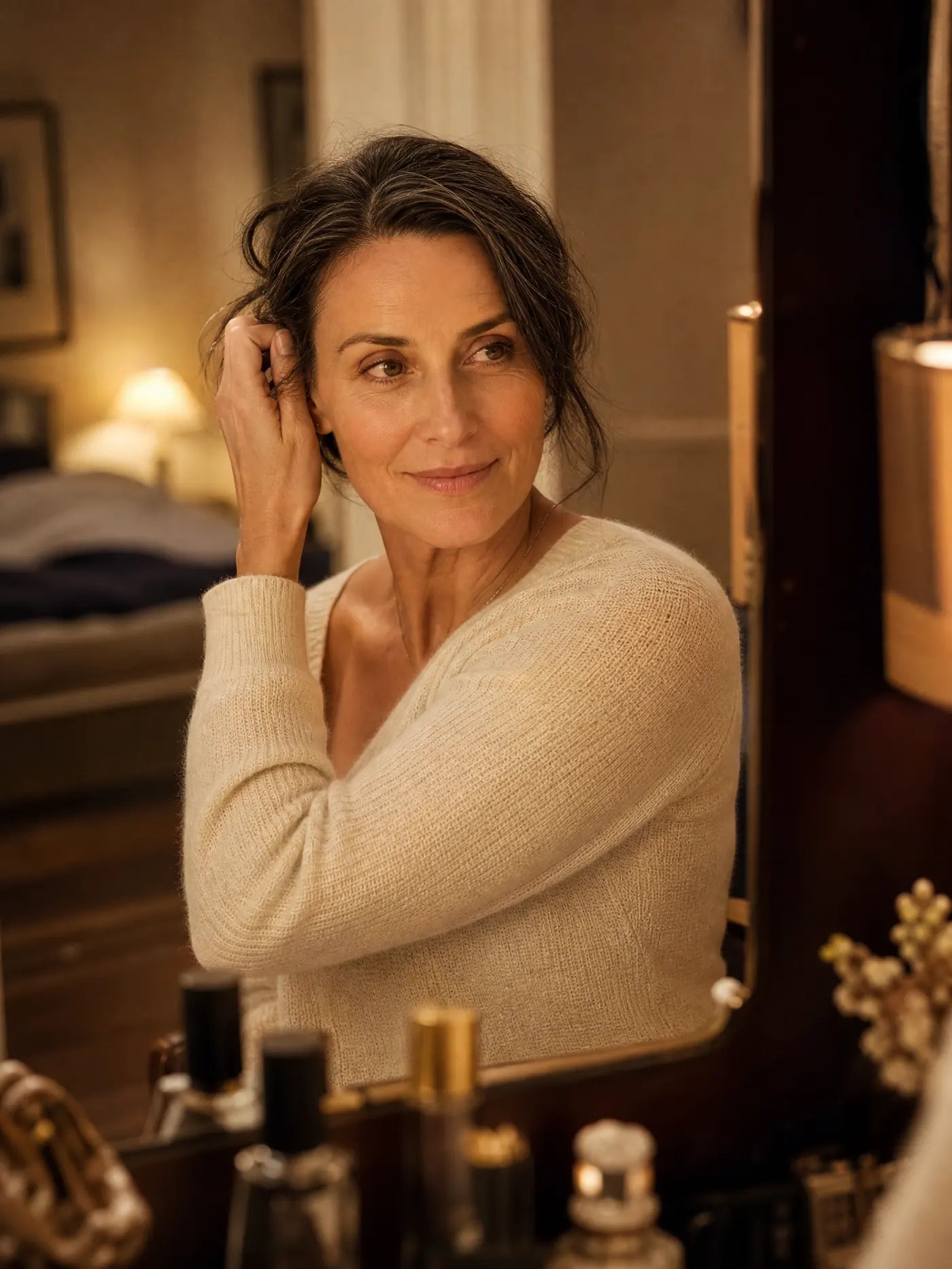 A woman at her vanity in lamplight